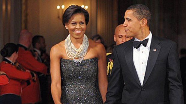 Sparkling ... Michelle Obama in Peter Soronen's sequinned gown and Binn's pearls.