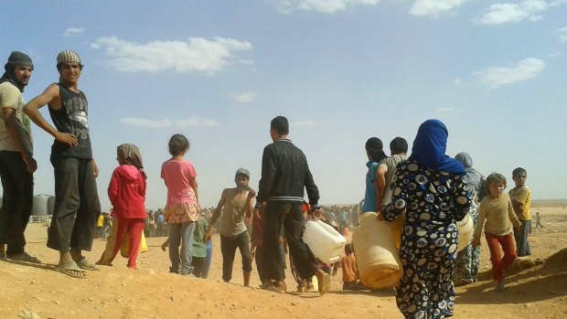 Syrian refugees in June gather for water at the Rukban refugee camp in Jordan's northeast border with Syria.