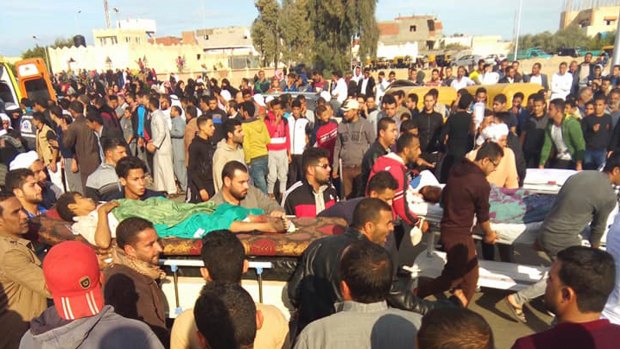 Injured people are evacuated from the scene of a militant attack on a Sufi mosque in Bir al-Abd in the northern Sinai Peninsula of Egypt.