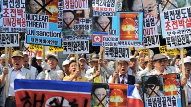 Over the border...South Korean protestors shoutedslogans and held portraits of the North Korean leader, Kim Jong-Il, following the nuclear test on Monday.
