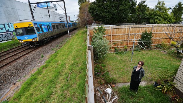 Michelle Clarke in the backyard of her Carnegie home which backs on to the rail tracks where sky rail will be built. 