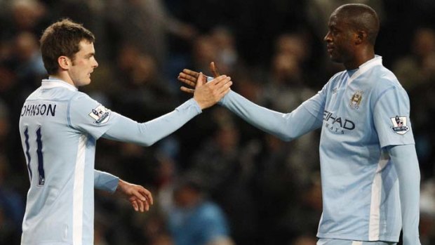 Manchester City's Adam Johnson (left) celebrates his goal against Norwich City with Yaya Toure.