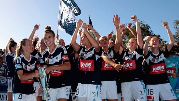 Melbourne Victory players celebrate after winning the W-League grand final against the Brisbane Roar at Lakeside Stadium on Sunday.