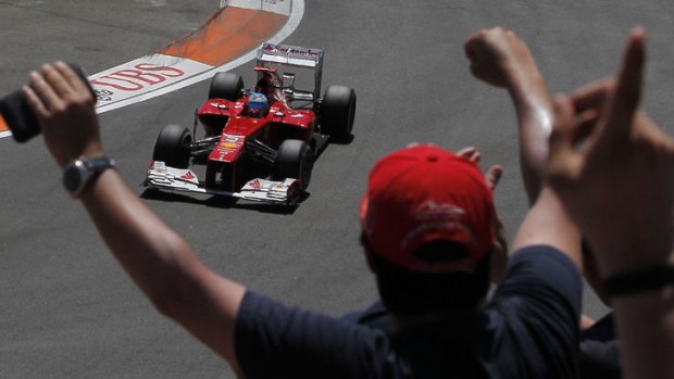 Ferrari's Fernando Alonso is cheered by fans as he wins his home Formula One Grand Prix, in Valencia.