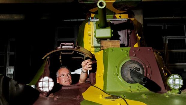 Australian War Memorial restorer John Kemister sits inside  a Japanese Type 95 Ha-Go tank in the AWM annex.