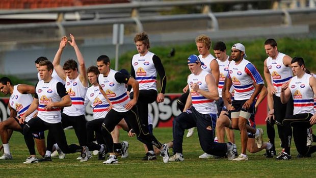 Pack mentality: The Western Bulldogs stretch out at training yesterday.