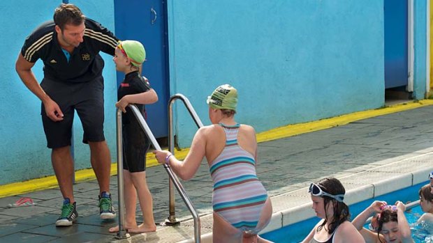 King of the kids ... Ian Thorpe meets swimmers at the Tooting Bec pool.