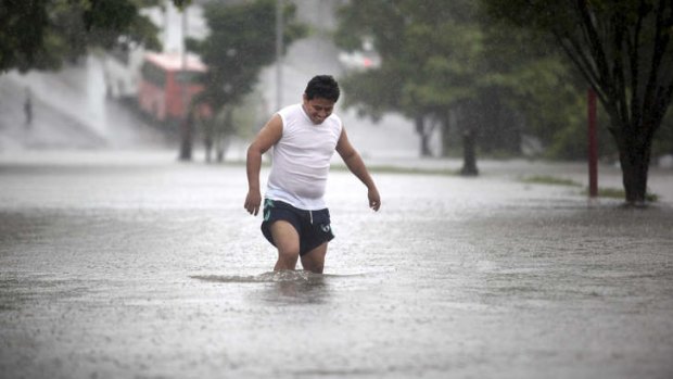 Soggy reception: A man walks through a flooded street in the Gulf port city of Veracruz, Mexico.