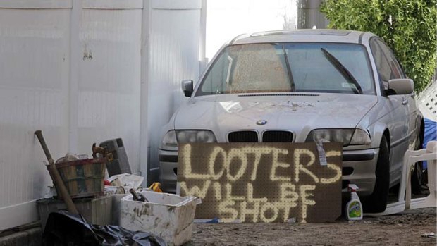 Aftermath ... a sign warns away looters after superstorm Sandy, in Queens, New York.