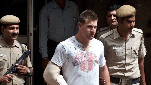 Royal headache ... Luke Pomersbach is ushered to a court appearance in New Delhi on Friday. His passport has been taken.