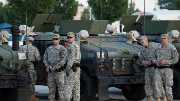 National Guard troops arrive at a mall complex that serves as staging for the police in Ferguson, Missouri.