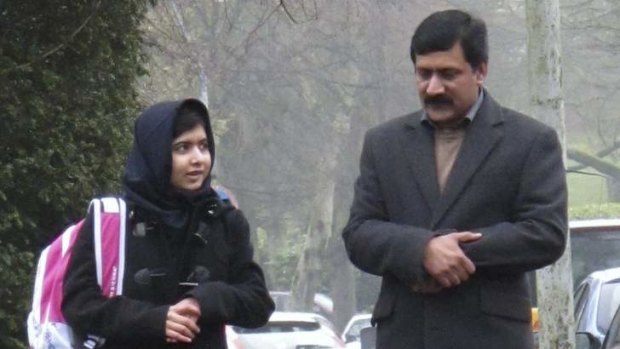 Fighter for education ... Malala Yousufzai walks to school with her father Ziauddin.