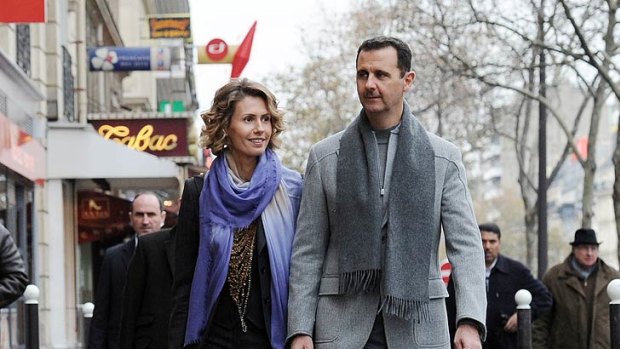 Kept 'beautiful aides' ... Bashar al-Assad takes a stroll around Paris with his wife Asma in 2010.