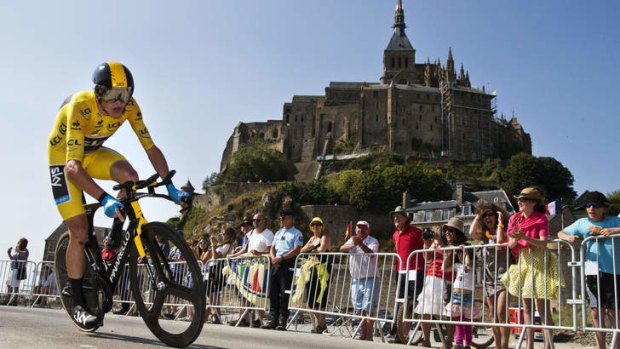 At his peak: British Team Sky rider Christopher Froome cycles past Mont-Saint-Michel.
