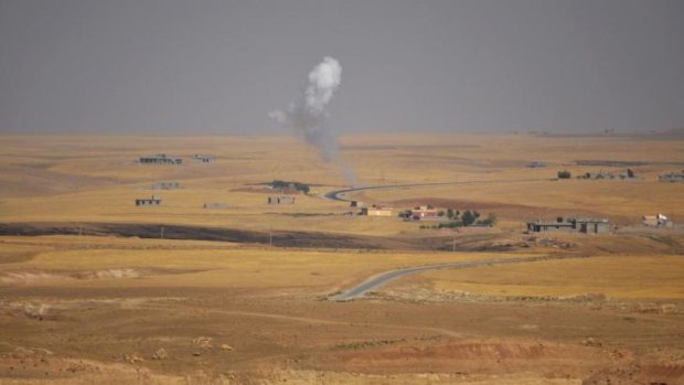 Smoke rises during clashes between Kurdish "Peshmerga" troops and militants of the Islamic State on the outskirts of Sinjar, west of Mosul.