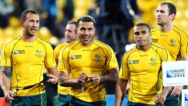 Snatching victory from the jaws of defeat ... Wallabies Quade Cooper, Digby Ioane and Will Genia celebrate after their quarter-final win over South Africa.