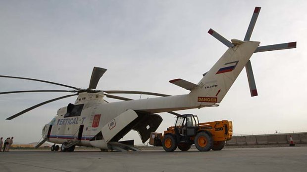 An Mi-26 helicopter is loaded with equipment at Kandahar Airfield.