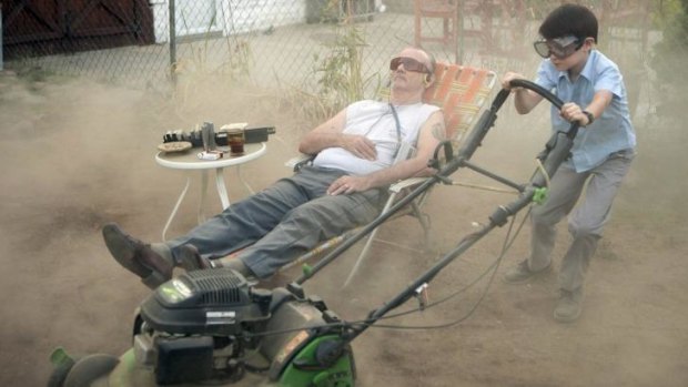 Lawn story: Vincent (Bill Murray) puts his neighbour's son Oliver (Jaeden Lieberher) to work.
