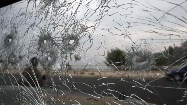Troops trade fire ... a bullet-riddled windscreen of a Lebanese army vehicle.