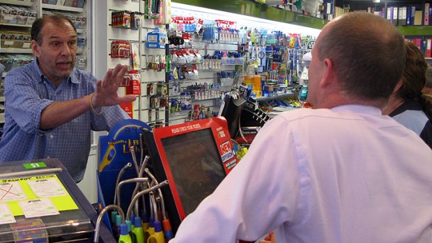 A shopkeeper talks to Campbell Newman in Ashgrove.