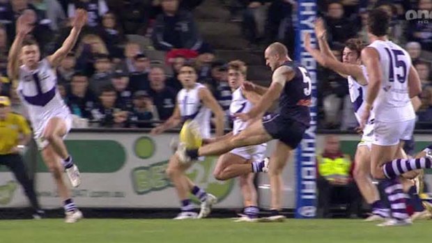 The shot that triggered complaint: Chris Judd rolls his ankle in the clash with the Dockers.