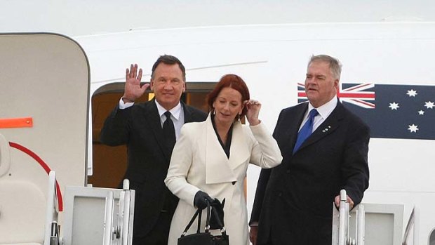 Prime Minister Julia Gillard and her partner Tim Mathieson are greeted by ambassador Kim Beazley as they arrive at Andrews Air Force Base in Maryland.
