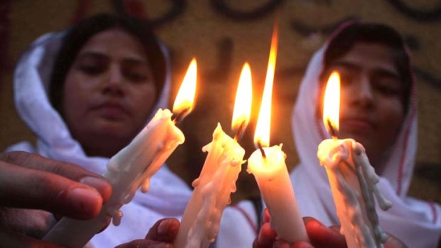 Pakistani peace activists light candles in support of a meeting between foreign ministers of Pakistan and India in Karachi.