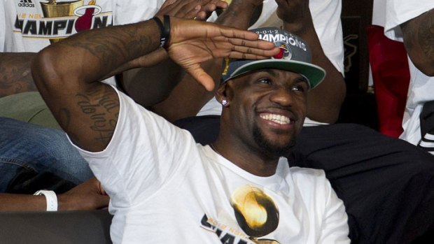 We salute you: Miami Heat's LeBron James acknowledges fans as the side celbrates its NBA championship win.