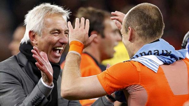 Proud of his team ... Netherlands coach Bert van Marwijk celebrates with Arjen Robben.