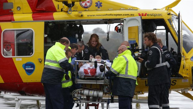 Medics work to stabilise shark attack victim David Quinlivan before he was flown by rescue helicopter to John Hunter Hospital. 