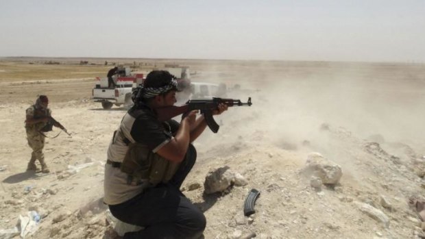 Tribal fighters engage with the Islamic State near the town of Haditha, north-west of Baghdad.