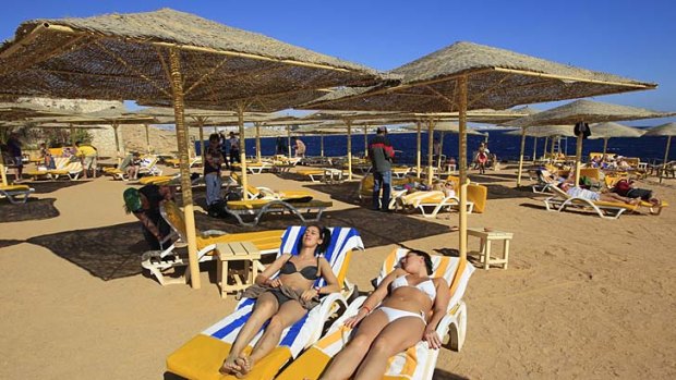 Bikini-clad tourists enjoy the beach in the Red Sea resort town of Sharm el-Sheikh ... bikinis have been at the centre of a growing debate over plans for Egyptian tourism.