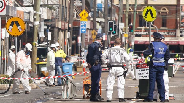 Asbestos removalists work at the scene of the explosion in Rozelle.
