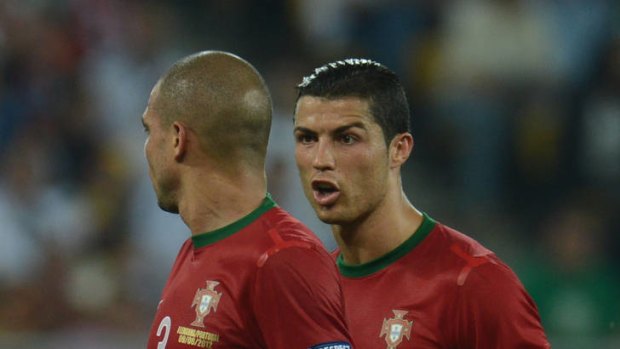 Portuguese forward Cristiano Ronaldo (right) speaks to his teammate Pepe.