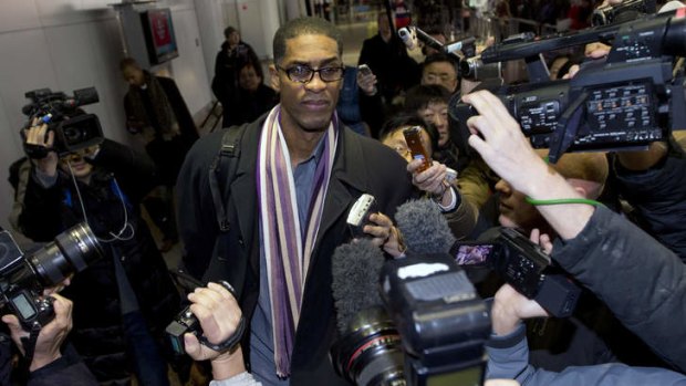 Former NBA basketball star Charles Smith is mobbed by journalists upon arrival at the Beijing Capital International Airport. A squad of former basketball stars led by Dennis Rodman had a friendly game with North Korean basketball players in Pyongyang.