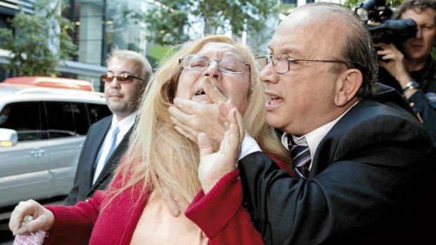 Gag order … Carlo Sica tries to stop his wife, Anna, from speaking to the media outside court last year.
