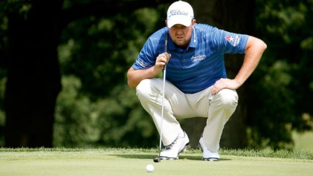 Marc Leishman lines up a putt during the first round of the World Golf Championships in Akron, Ohio.