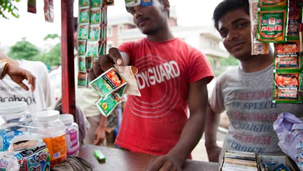 Men selling chewing tobacco at a roadside stall in Gurgaon, India.