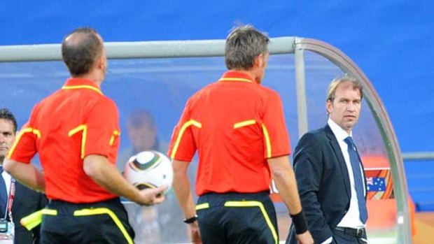 Coach Pim Verbeek stares at referee Roberto Rosetti after he gave Harry Kewell a red card.