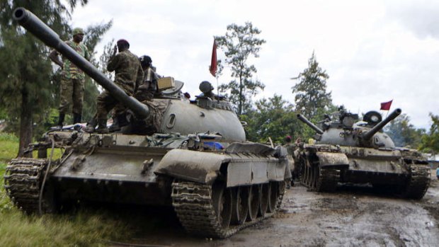 Democratic Republic of Congo regular army soldiers sit on tanks as they rest in Rutshuru, on their way to the Mbuzi mountain, after recapturing the area from M23 rebels.