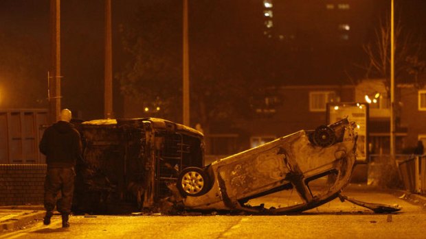 World turned upside down: burnt and upended cars in the aftermath of rioting and arson in Salford, Manchester.