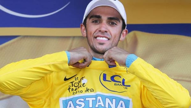 Alberto Contador of Spain dons the yellow jersey amid booing from the crowd.