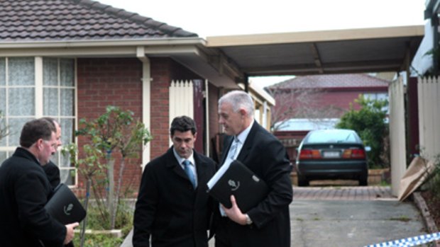 Tomahawk murder charge ... Homicide squad detectives outside the Narre Warren South home.