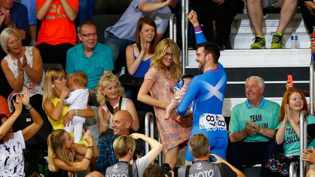 Cyclist Chris Pritchard of Scotland proposes to his partner in the stands of the Sir Chris Hoy Velodrome.