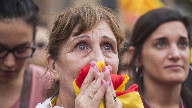 Pro independence supporters react as they wait outside the Catalan parliament for the result of a vote for independence.