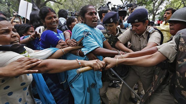 Supporters of India's main opposition Bharatiya Janata Party scuffle with police as they march towards the residence of the chief of India's ruling Congress party, Sonia Gandhi, during a protest rally in New Delhi April 21, in a third day of protests after the alleged rape and torture of a five-year old girl.