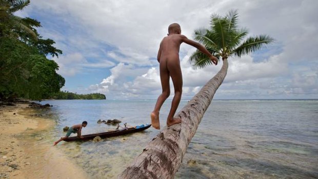 Children playing on the beach at Manus Island.