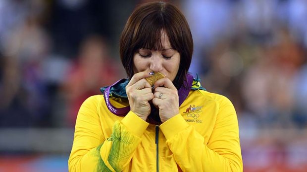 Golden girl ...Australia's Anna Meares kisses her gold medal on the podium after winning the women's sprint final.