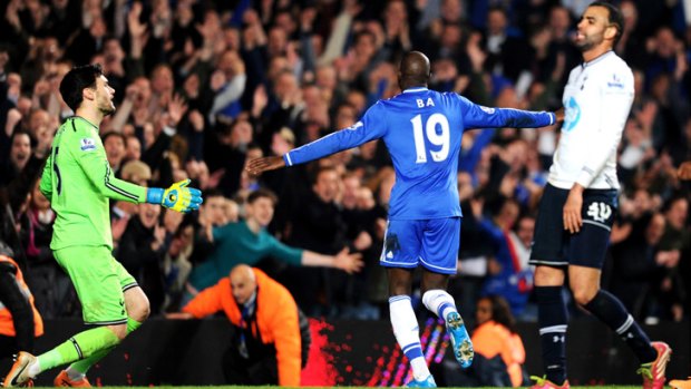 Cheslea's Demba Ba wheels away in delight after scoring his team's third goal against Tottenham.