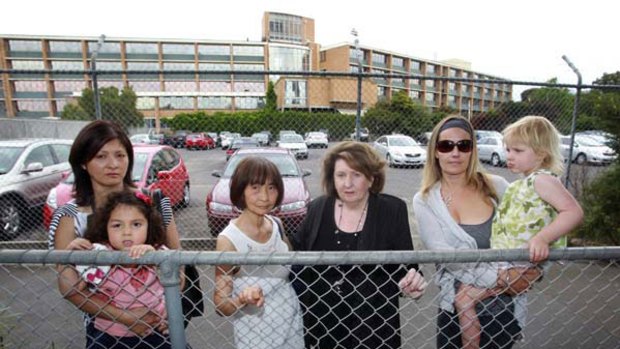 Plans to build 479 apartments on a site beside Toorak station have angered locals. Pictured: Helena Le and her daughter Coco, Petra Ward, Margot Carroll, Lara Dowd and her daughter Saskia.